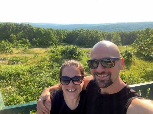 Nicholas and Heather Looney at Taum Sauk state park with trees in the distance
