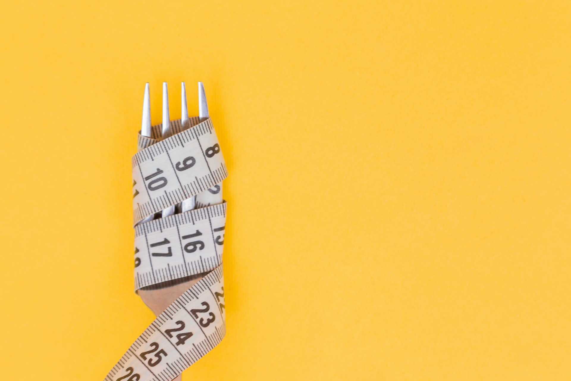 fork wrapped with tape measure